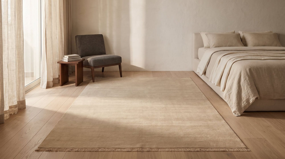 Cashmere Blend Rug in a styled bedroom, the warm oat colourway of handloom cashmere.