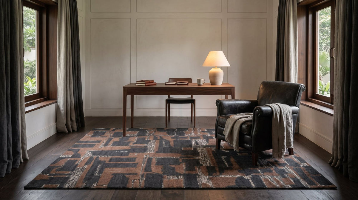A hand knotted New Zealand wool rug in a styled study on a dark oak floor.