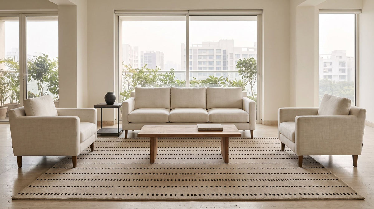 Greige Wool Rug in a styled living room with cream armchairs, hand tufted New Zealand wool in a warm grey.