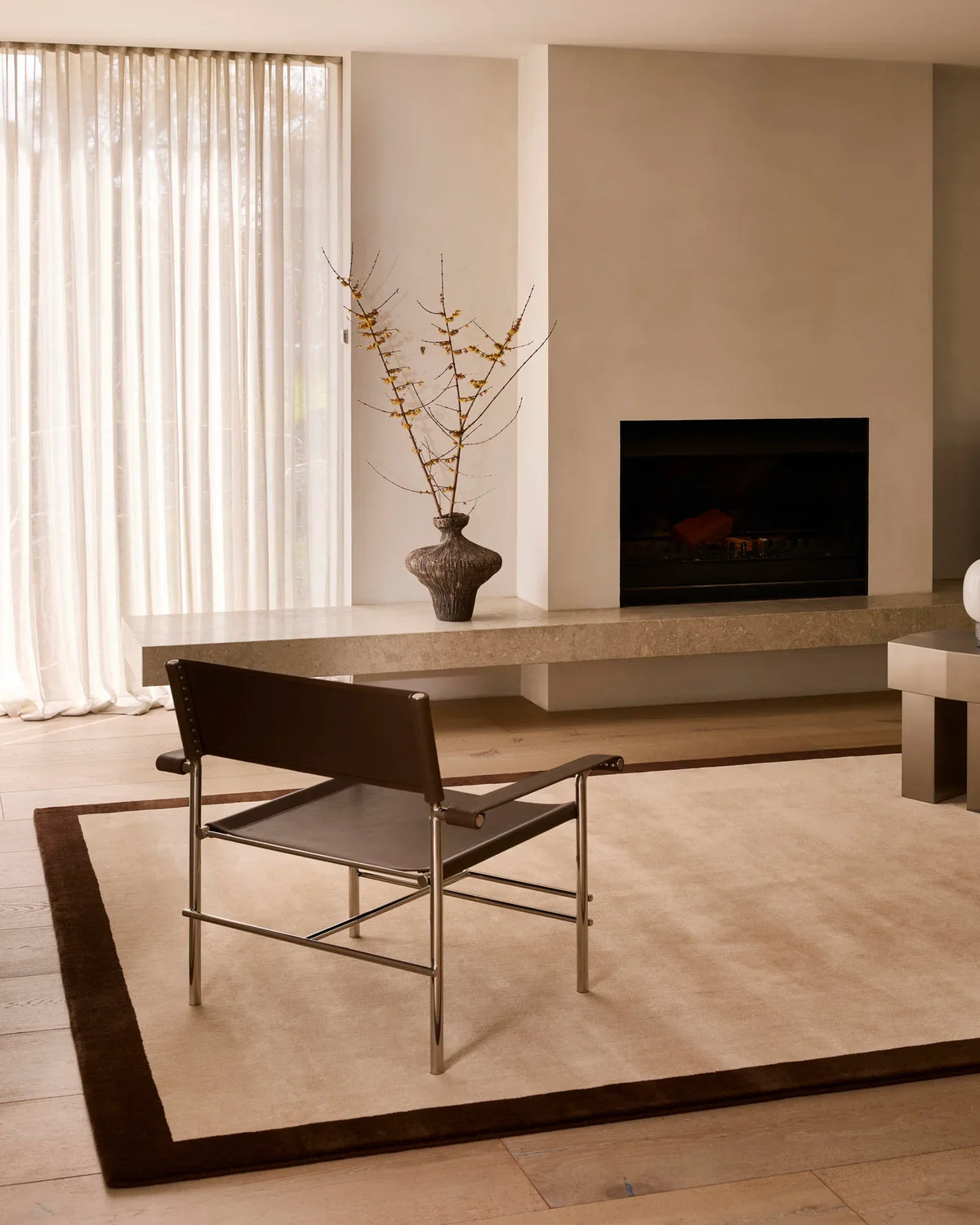 Handcrafted Rugberry area rug sized to an open-plan great room in strong daylight