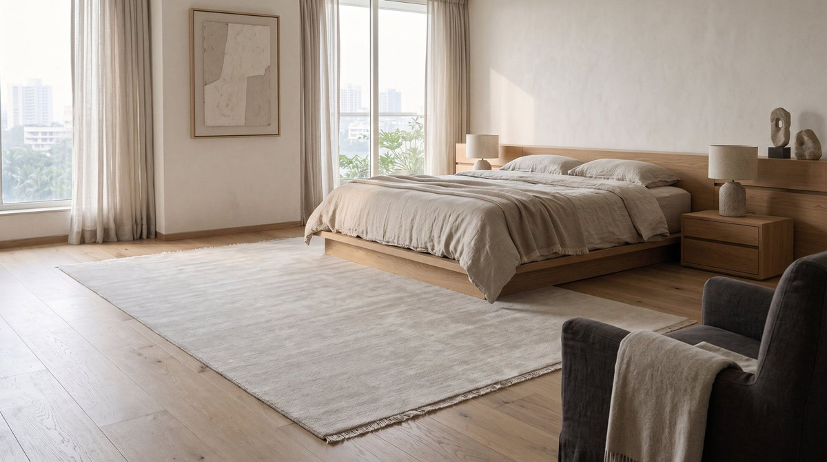 Cashmere Blend Rug in Salt, handloom cashmere, beside the bed. Room is a digital render; the rug is from a product photo.