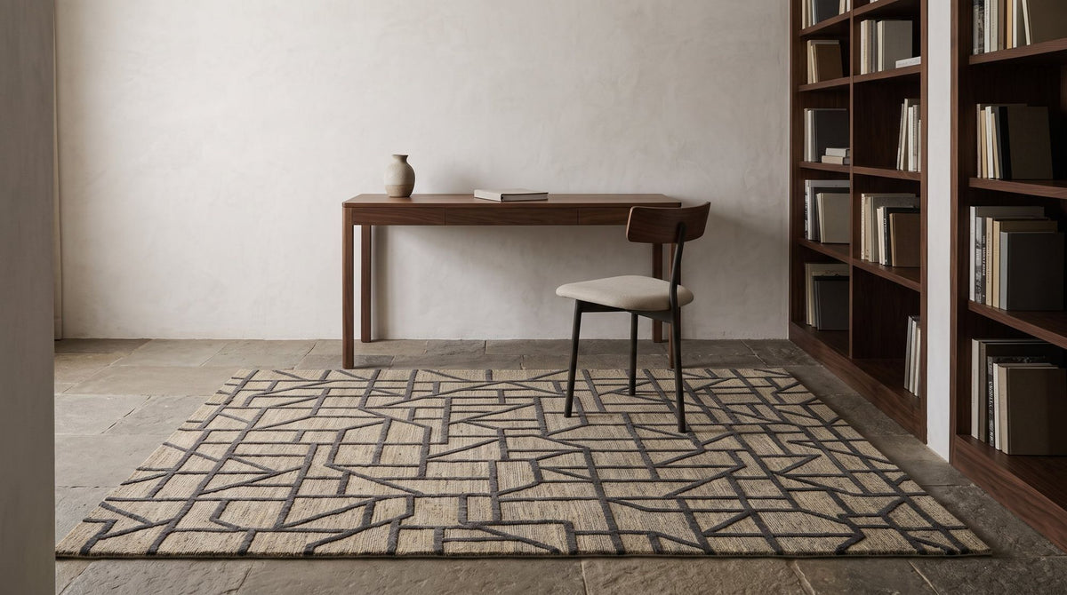 A hand knotted rug with raised charcoal lines in a study.